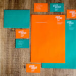 business cards, stationery and envelopes colorful design in orange and turquoise printed with ghost white toner