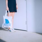 woman holding printed bag with wave shark design printed with ghost white tone